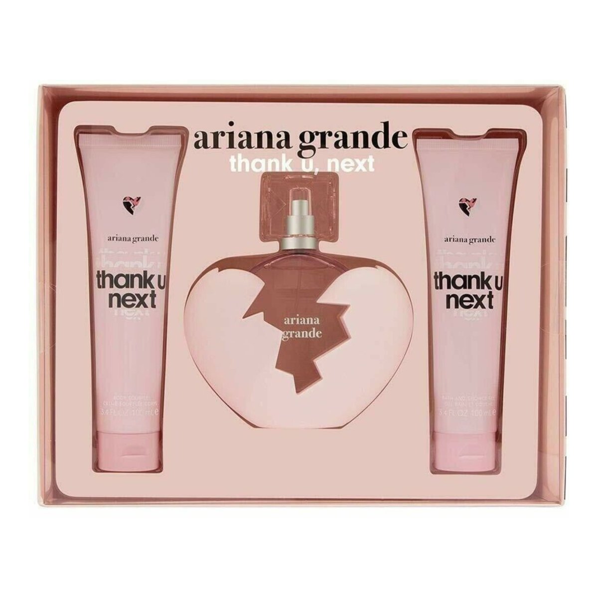 A boxed set of Ariana Grande's 'thank u, next' fragrance collection, featuring a 3.4 oz Eau de Parfum spray in a broken heart-shaped bottle, alongside matching 3.4 oz tubes of Body Soufflé and Bath and Shower Gel. - Ariana Grande - -